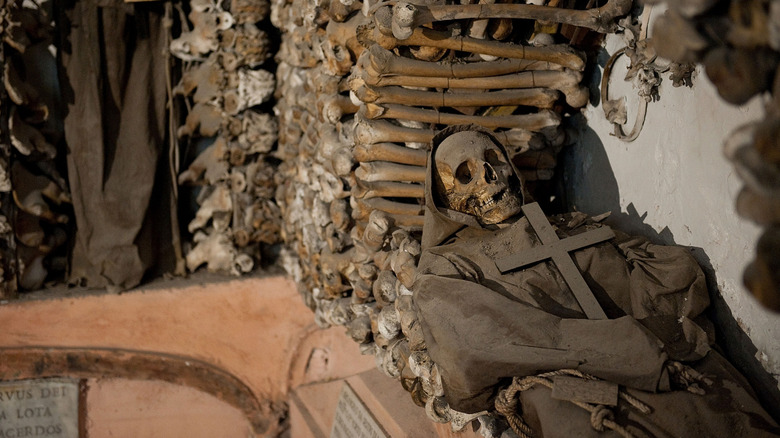 Bones surrounding the skeleton of a monk