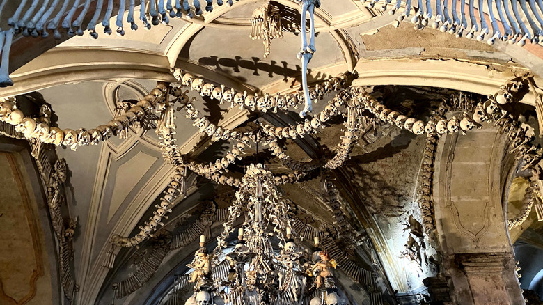 An intricate decoration of human bones on the ceiling of Sedlec Ossuary