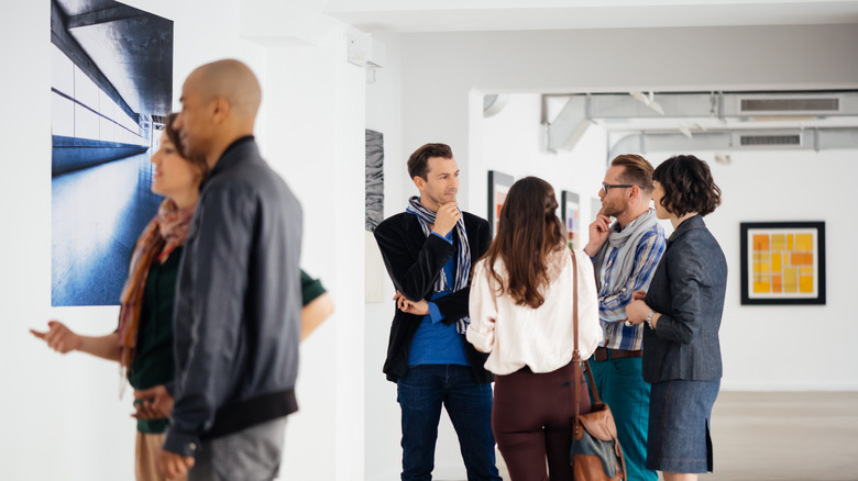 People mingling in art gallery