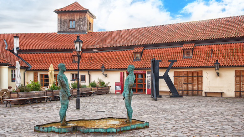 Bronze statues outside the Franz Kafka Museum in Prague