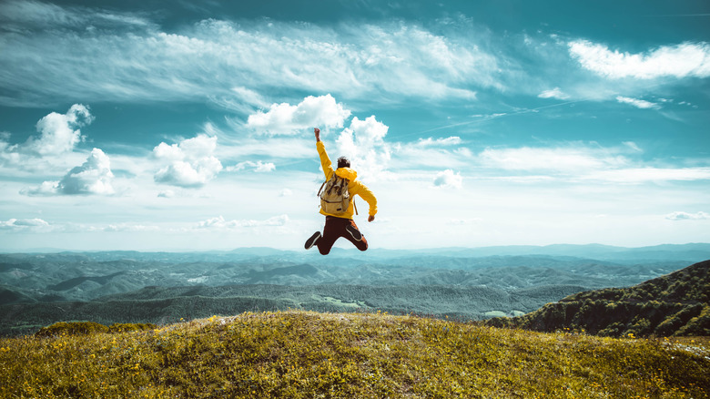 Man jumping for joy on mountain top