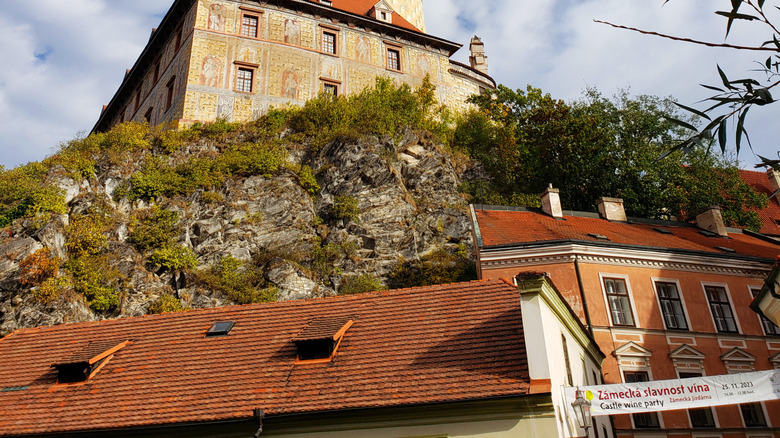 A multi-colored tower on a steep hill