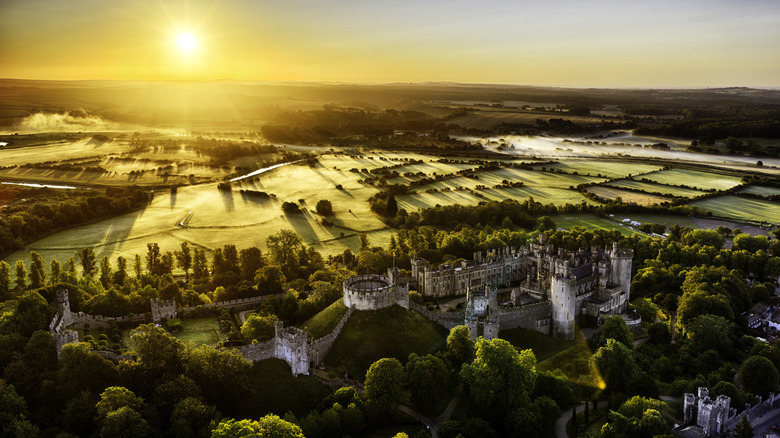 A sunrise at Arundel Castle overlooking green fields