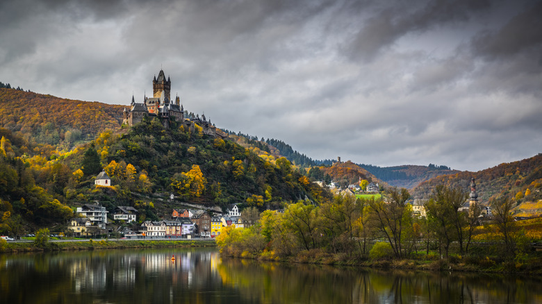 Cochem Castle overlooking the town and the River Mosel, surrounded by autumn foliage