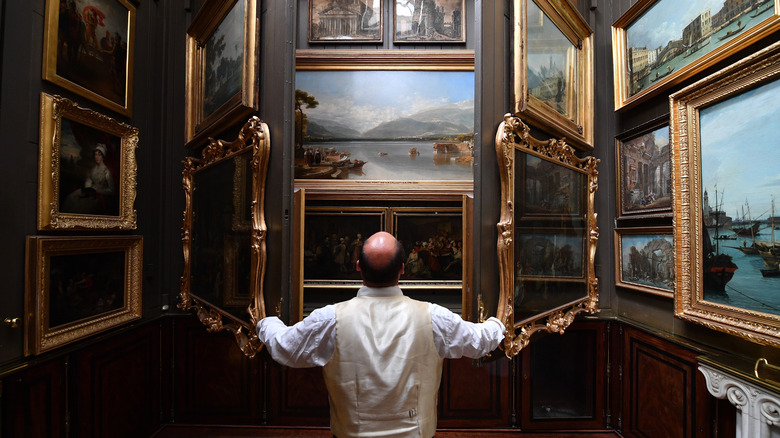 A man posing in the Picture Room of Sir John Soane's Museum