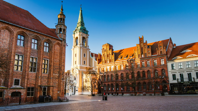 A charming town square with a tall church steeple in the corner