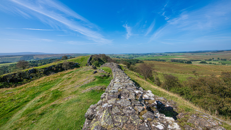 Hadrian's Wall running through rolling, hilly countryside