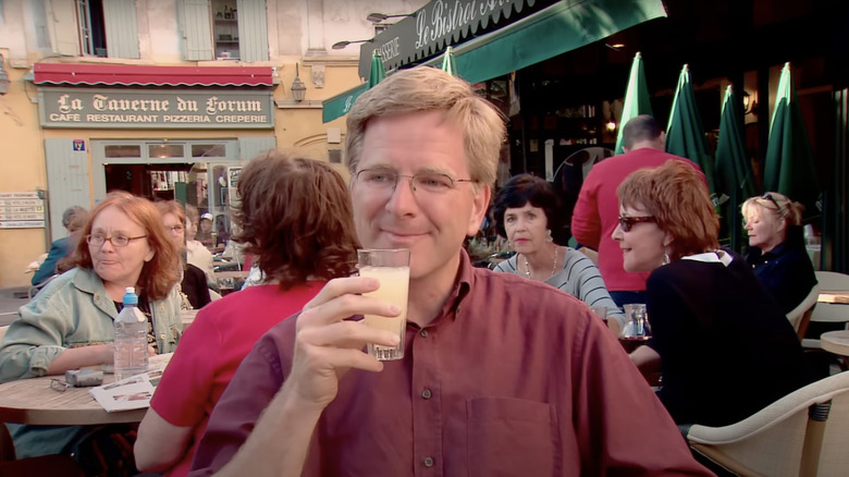 Rick Steves drinking pastis in Provence