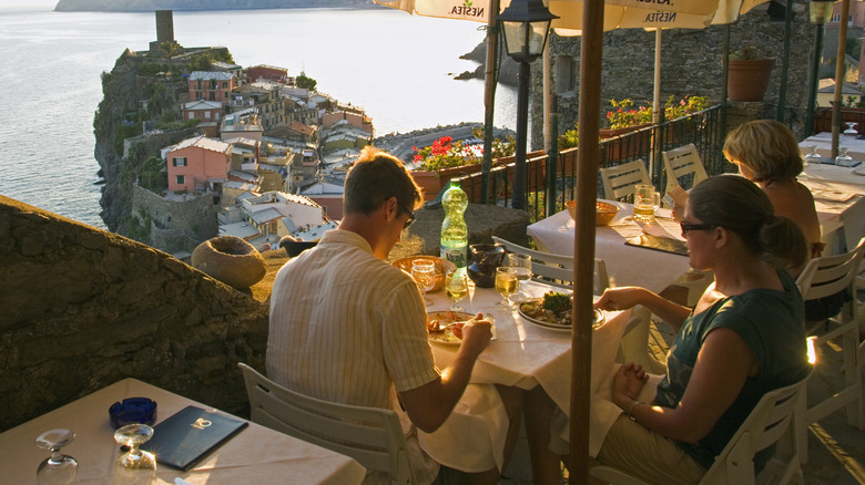 People eating at a restaurant terrace in Cinque Terre, Italy