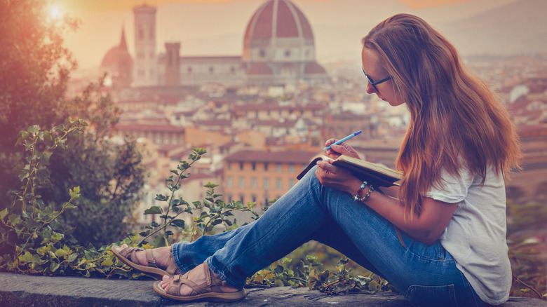 Woman in Venice writing in notebook