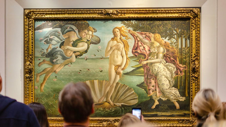 A crowd looks at Botticelli's Birth of Venus painting at the Ufizzi Gallery in Florence.