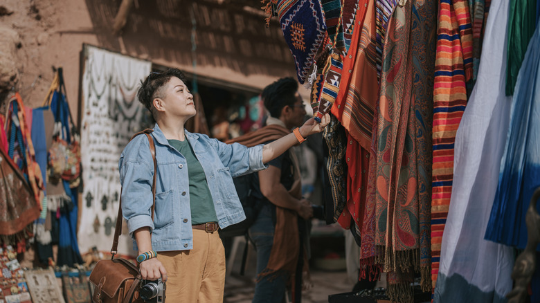 Woman observing items in a market