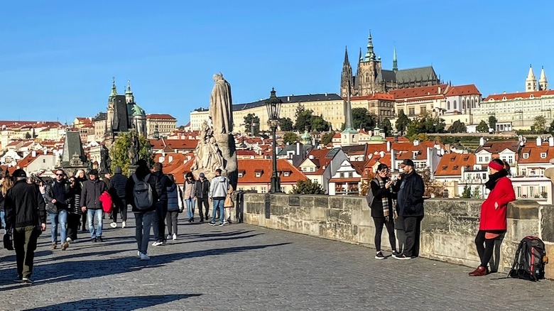 concrete path, pedestrians, buildings, steeples