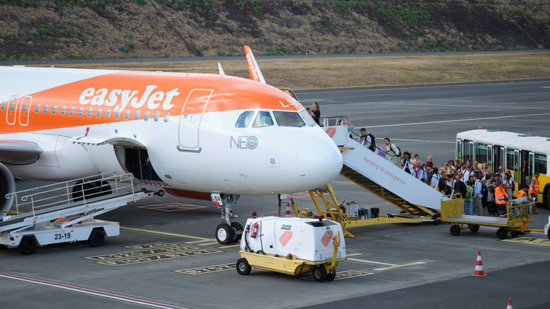 people boarding an easyJet plane