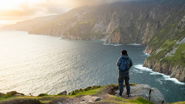 Traveler standing on Slieve League cliffside