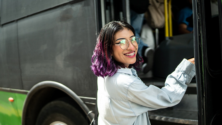 Woman hopping on tour bus