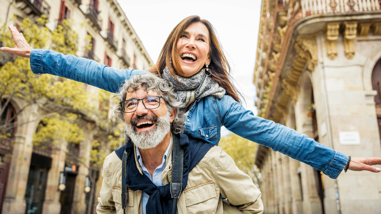 Smiling senior couple on street having fun