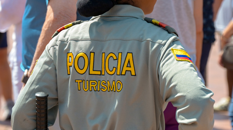 A rear closeup of the back of a Tourist Police officer in uniform