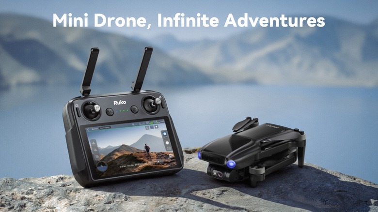 Ruko U11MINI 4K drone with independent controller system resting on a rock on mountainous lakeside terrain. There is a caption that says "Mini Drone, Infinite Adventures"