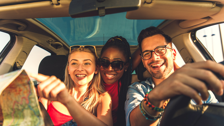 Friends reading map in car