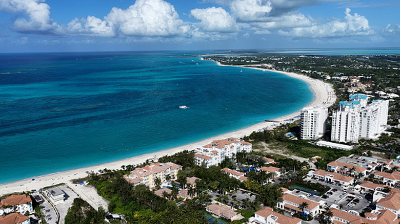 Aerial view of the Turks and Caicos city of Providenciales next to the ocean.