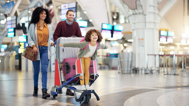 A family looking happy in an airport