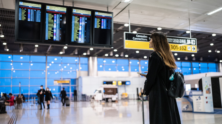Woman looking at an airport board