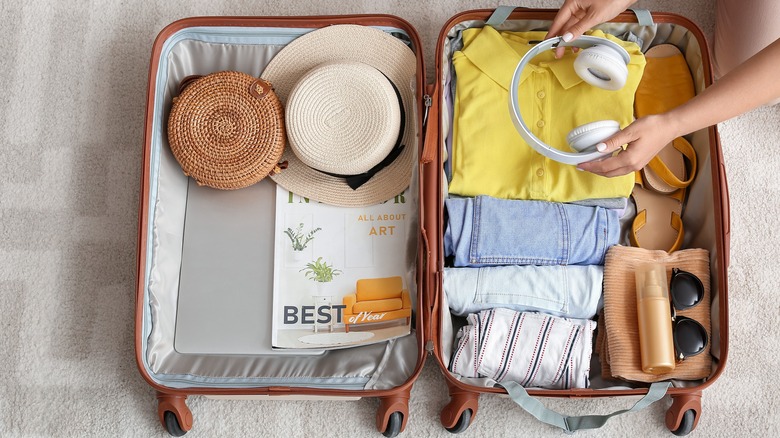 Women packing open suitcase