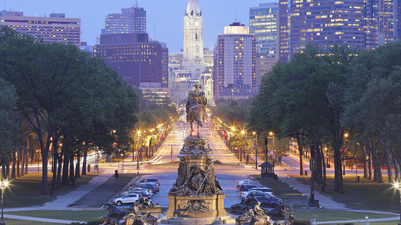 Tree-lined avenue Philadelphia skyline twilight