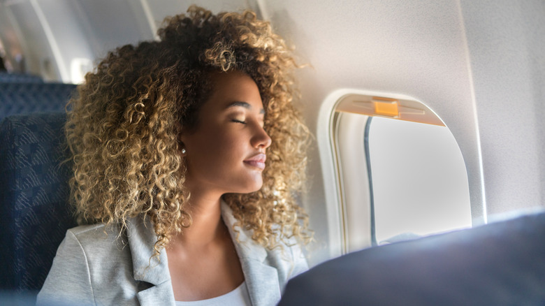 Woman sitting at window seat 