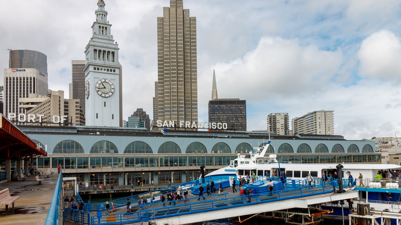 A ferry stopping at the Ferry Building Marketplace.