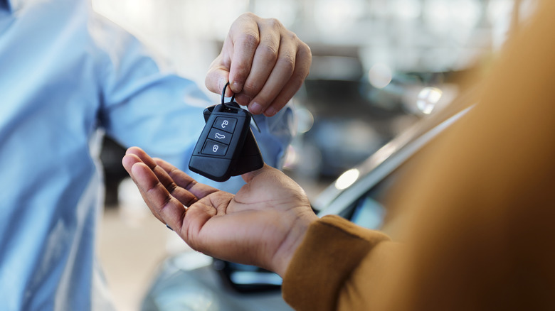 person handing over keys