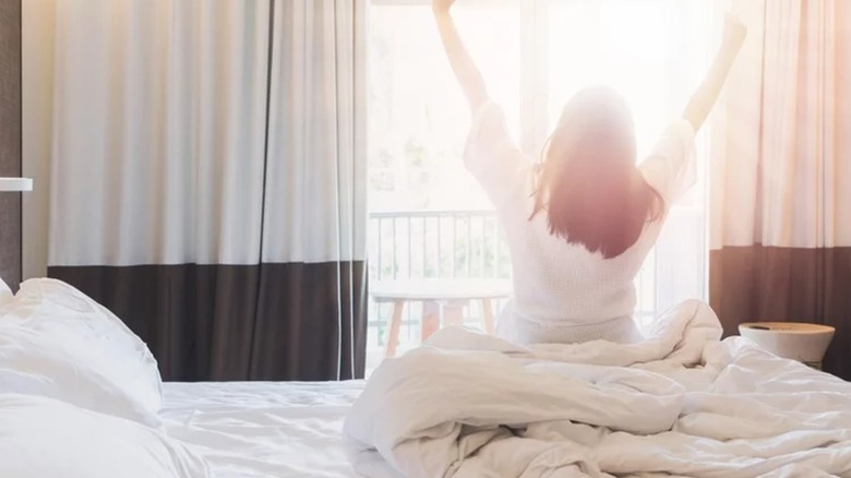 woman waking up in hotel room