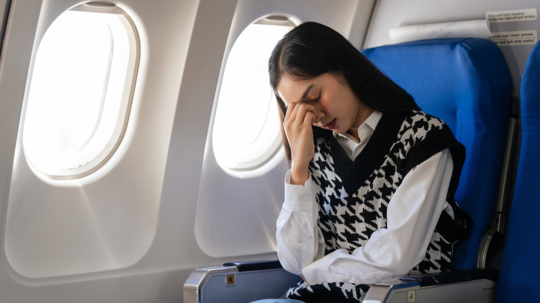 Plane passenger experiencing discomfort