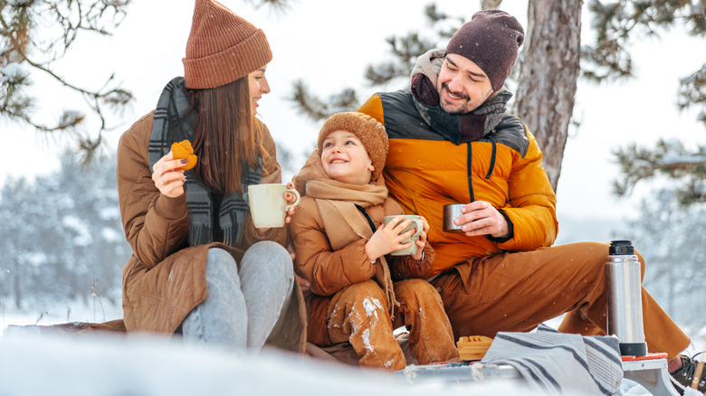 A family enjoying a winter picnic.