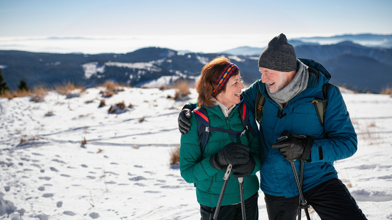 A couple hiking in the snow.