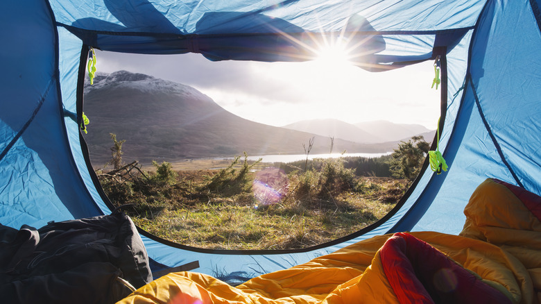 A view of a sunrise from inside of a comfy tent