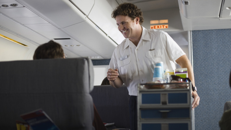 Flight attendant with beverage cart