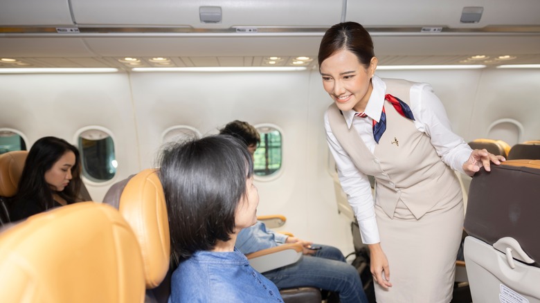 flight attendant speaking with passenger