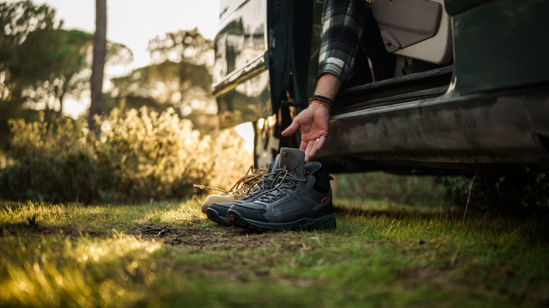 RV traveler reaching for hiking boots