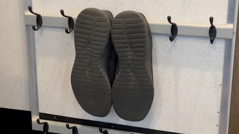 Shoes hanging from wall hook