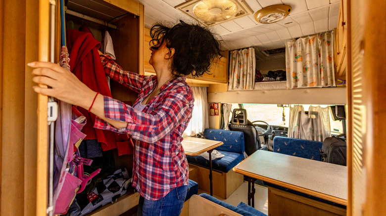 RV traveler organizing campervan closet