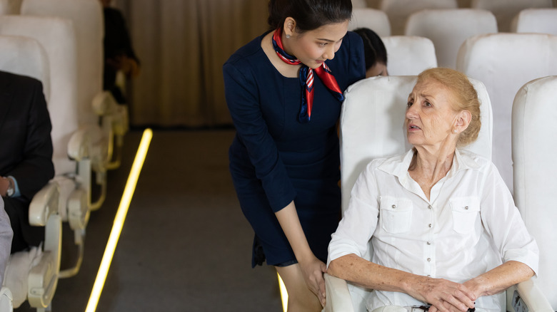 Older passenger speaking to crew