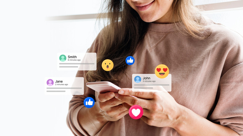 A woman enters social media posts into her phone