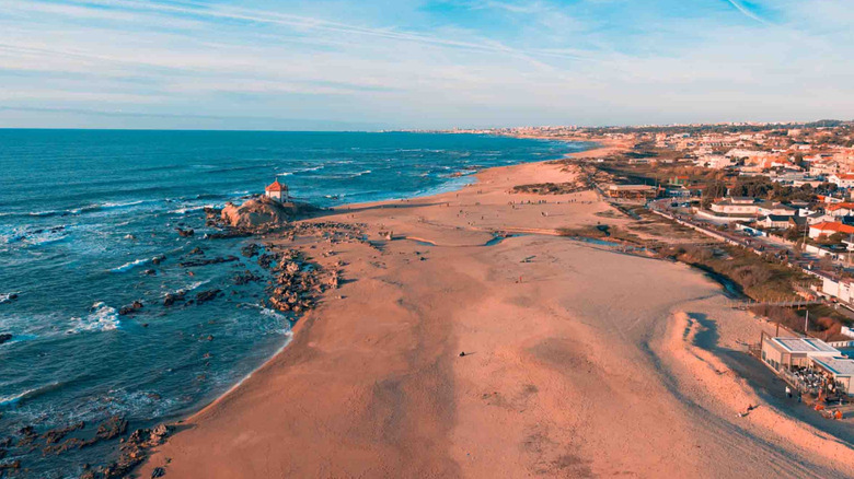 Miramar beach at sunrise with chapel on the rocks