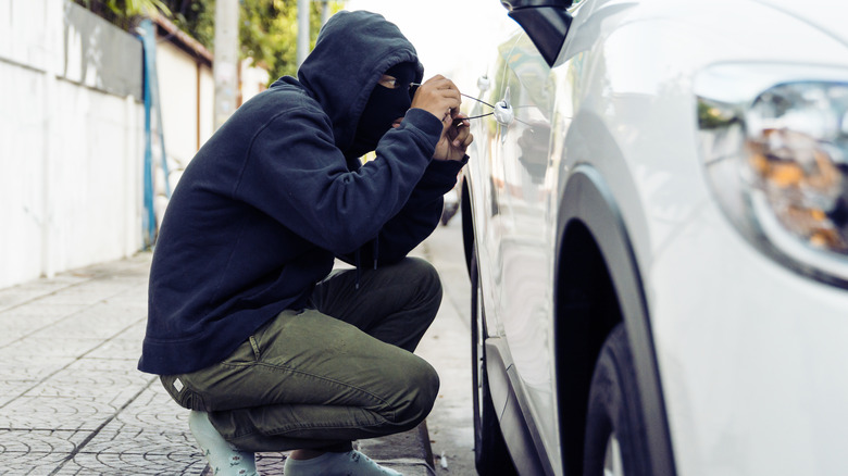Car thief picking locked door