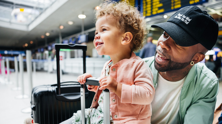 Man and child at airport