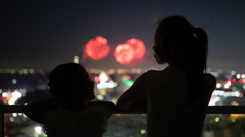 parent and child watching fireworks
