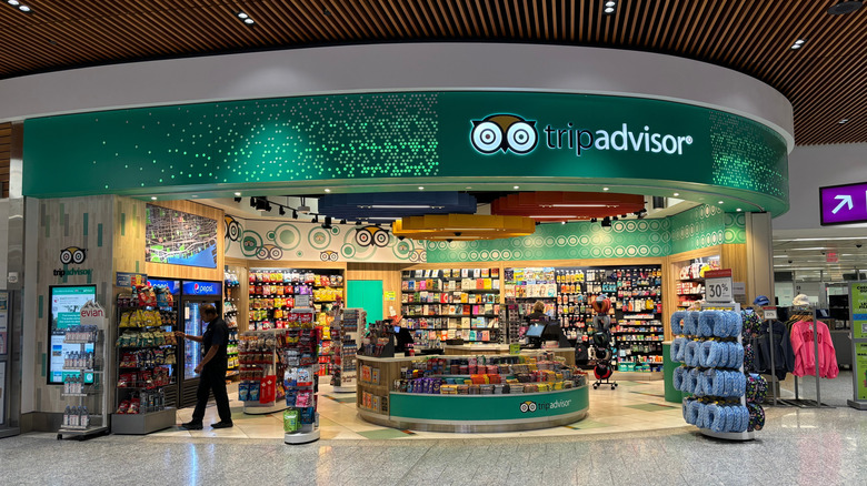 An image of a TripAdvisor shop located inside an airport terminal selling travel related products