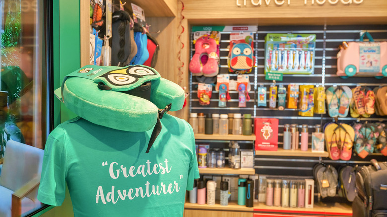 An image showing the inside of a TripAdvisor shop with a green t-shirt